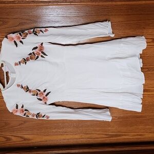 White floral embroidered mini dress with ruffles.